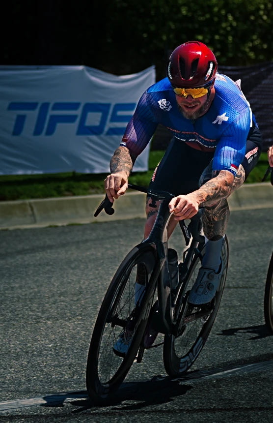 Cyclist racing through a sunlit corner.